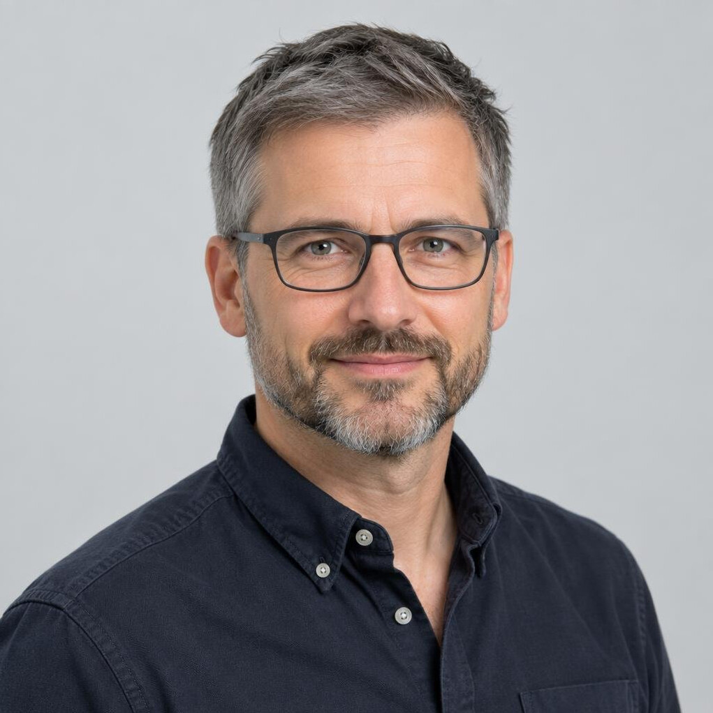 Portrait of a middle-aged Swiss man with glasses and a beard
