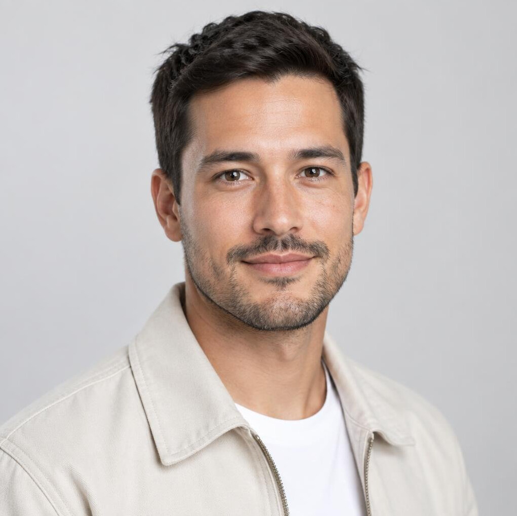 Portrait of a young man with dark hair and a light jacket